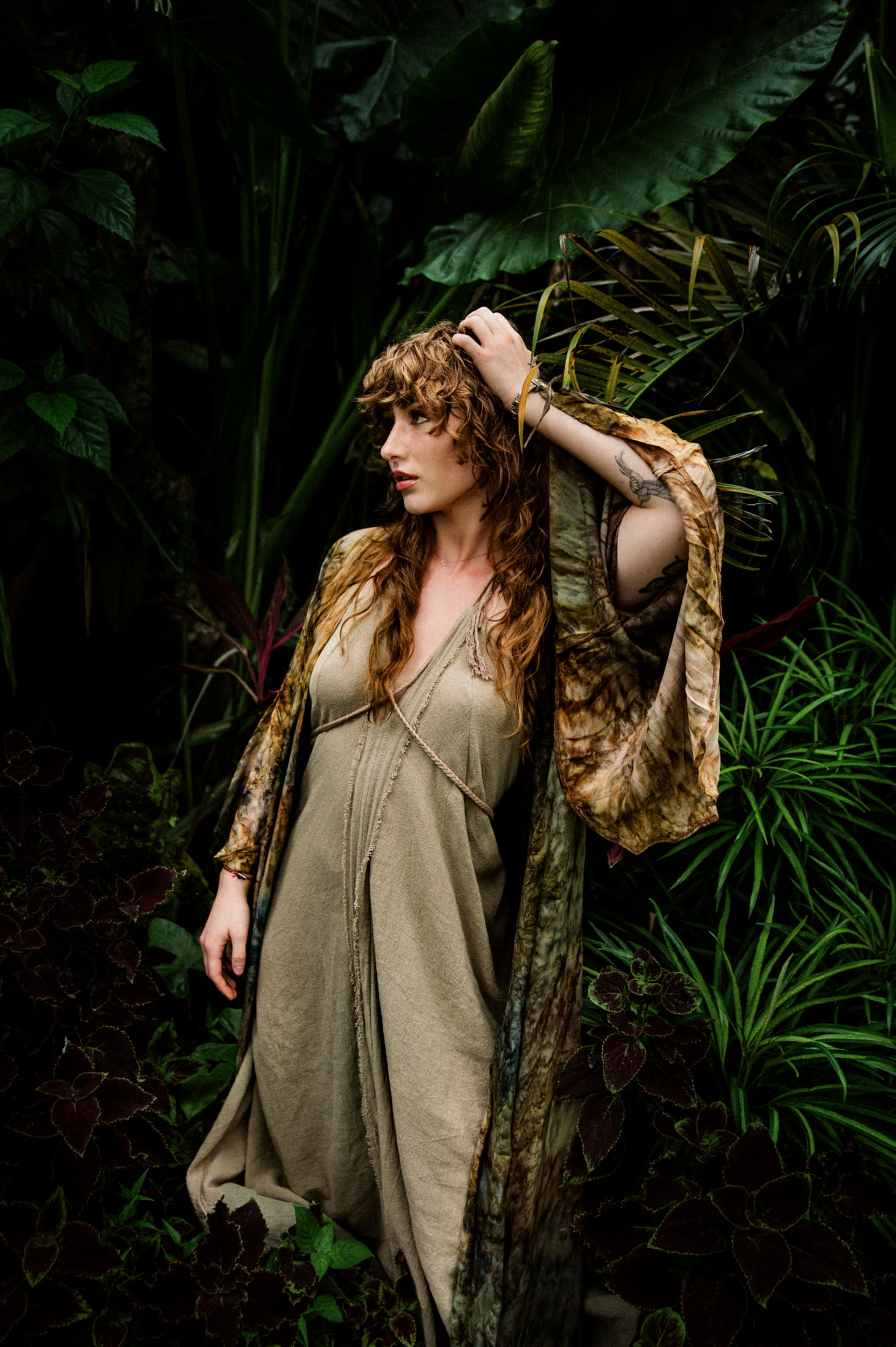 Kaia Jette standing in deep green foliage