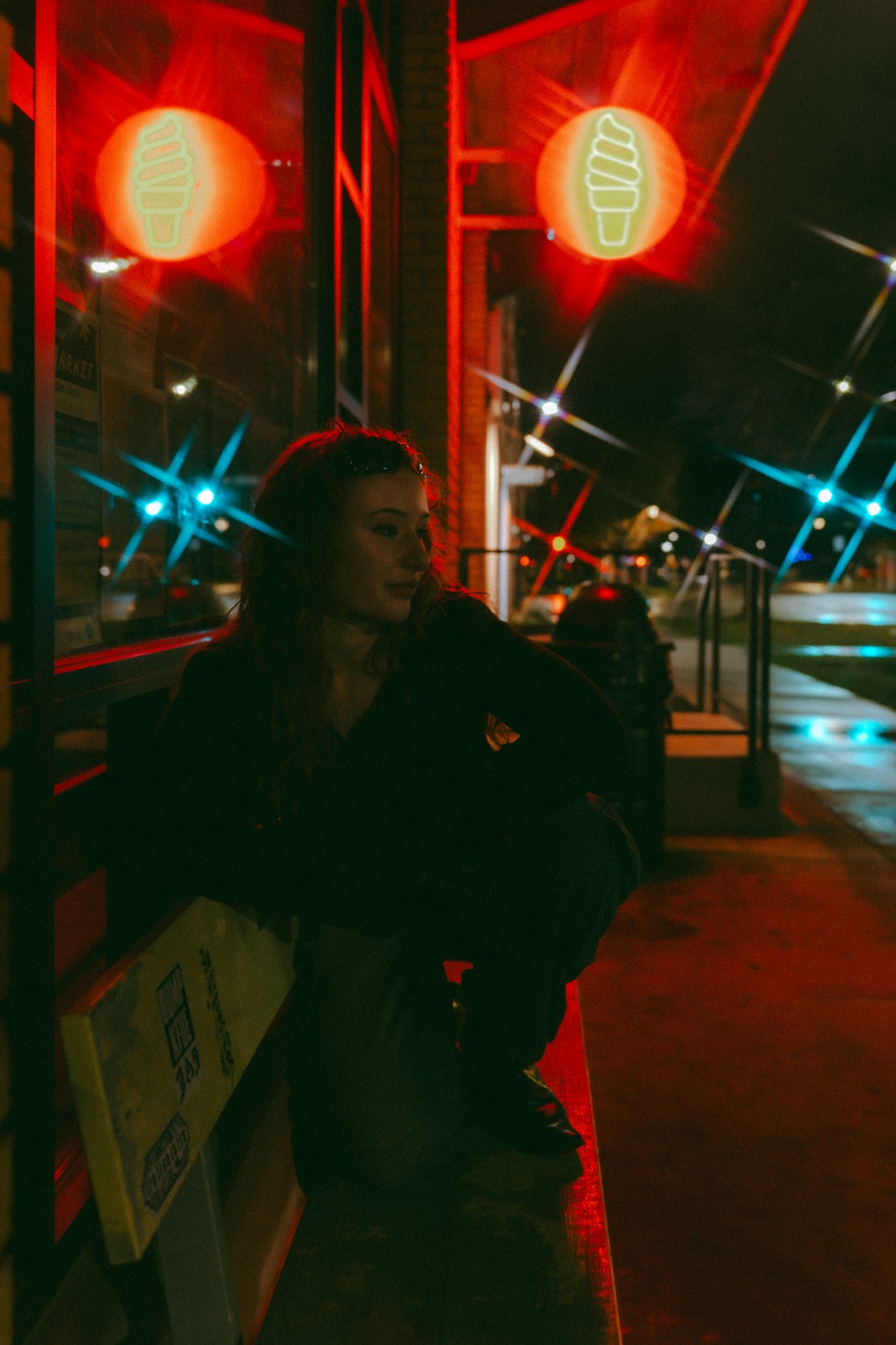 Kaia Jette under red neon storefront lights